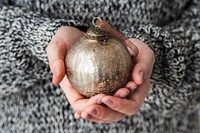 Woman holding a gold bauble