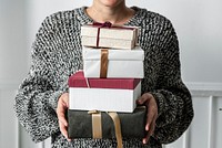 Woman carrying a stack of presents