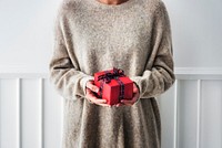 Woman holding a red present