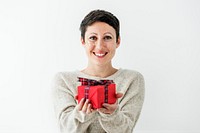 Cheerful woman holding a red present on her hands