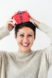 Woman putting a red present on her head