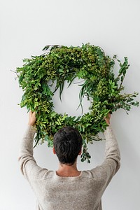 Woman hanging a fresh Christmas wreath