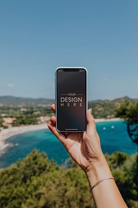 Woman holding a phone at the beach mockup