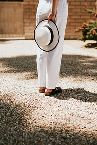 Woman in white waiting in a driveway