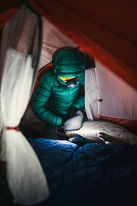 Preparing a sleeping bag in a tent for the cold night