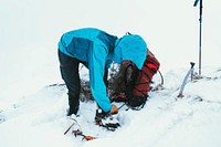 Mountaineer wearing Crampons before hiking