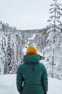 Hiker looking out over a snowy landscape