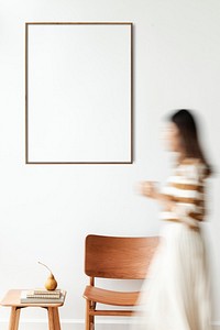 Blurred woman walking pass a blank frame