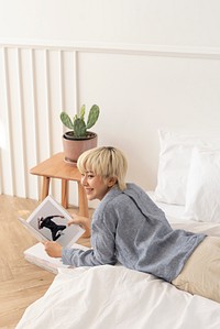 Asian woman reading a magazine in the bed