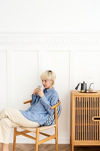 Asian woman having a coffee in her living room