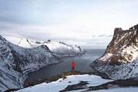 Hiker walking up Segla mountain in Norway