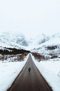 Young woman hiking up the road in Norway