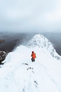 Hiker up in Reinebringen in the Lofoten Islands, Norway