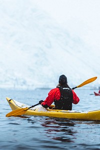 Woman paddling a kayak in Lofoten, Norway