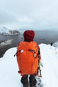 Hiker up in Reinebringen in the Lofoten Islands, Norway