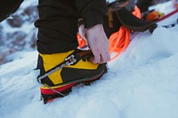 Man walking in the snow with crampons