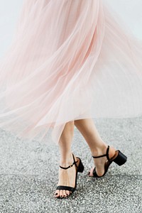 Woman in a pink chiffon skirt dancing on a granite floor