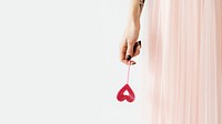 Woman holding a red heart on a stick wallpaper