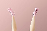 Woman wearing pink socks against a pink background 
