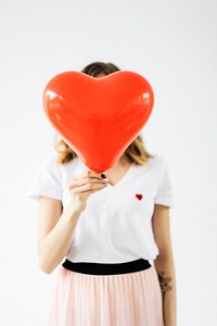 Woman holding a red heart balloon for Vallentines day