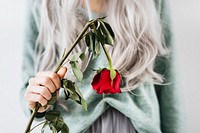 Emotional woman with a red rose 