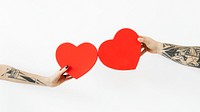 Tattooed hands holding red hearts wallpaper