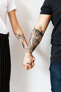 Couples holding hands against a white background