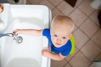 Little girl washing her hands in the sink health photo aerial view
