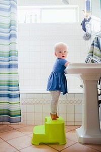 Cute toddler washing hands in the bathroom health photo