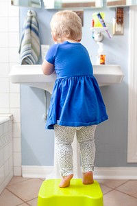 Little girl washing her hands in the sink health photo