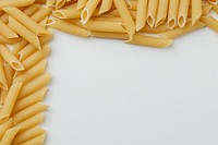Uncooked penne pasta frame on white