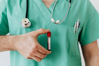 Surgeon holding a blood test tube