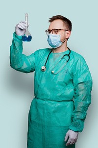Microbiologist in a green gown holding a volumetric flask mockup