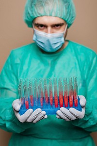 Surgeon holding test tube samples