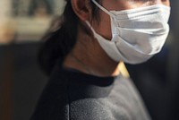 Woman wearing a face mask in public to prevent coronavirus infection