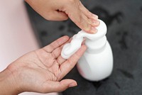 Hand pumping foam soap from a bottle 