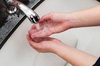 Washing hands under running water to prevent coronavirus contamination