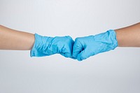 Medical staff bumping fists to support each other during coronavirus pandemic