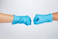 Medical staff bumping fists to support each other during coronavirus pandemic