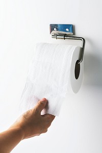 Hand getting toilet paper
