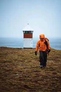 Traveler visiting a lighthouse at the Faroe Islands