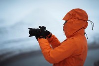 Landscape photographer at snowy Hv&iacute;thamar mountain in the Faroe Islands