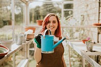 Female gardener with a blue watering can