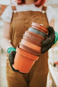 Gardener holding empty flower pots