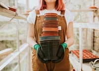 Gardener holding empty flower pots