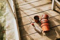 Empty flower pots near a trowel