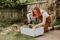 Woman planting in small home garden