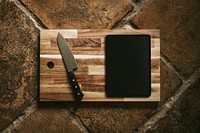 Tablet mockup on wooden cutting board flatlay
