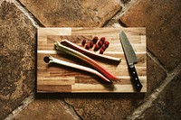 Fresh vegetable and raspberry on a wooden cut board flatlay