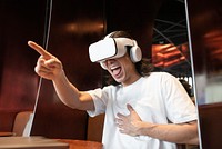 Asian man watching funny movie via VR headset